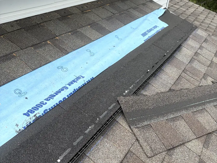 New roof vent being installed with synthetic underlayment and fresh shingles